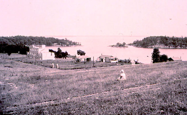 Photograph of the cottages incorporating the Guard House and Deadhouse ca. 1924-1936 (Queen's University Archives A.Arch V23).